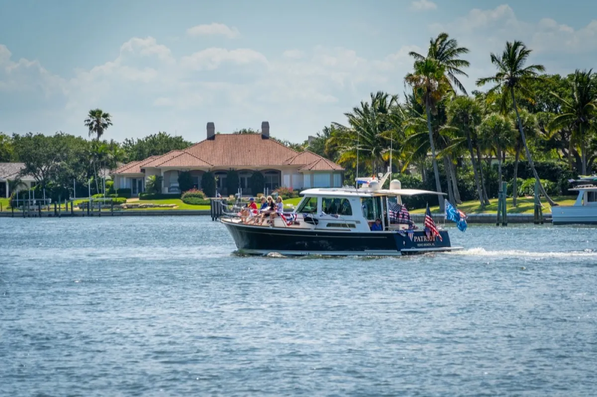 Riverfront estate on the Indian River in The Moorings with a classic yacht passing